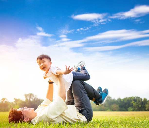 istock Happy Father and son playing in the park 1287387051