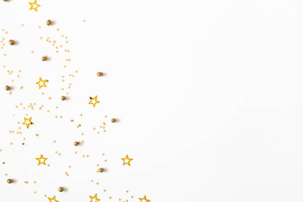 Christmas composition. Christmas golden confetti on white background. Flat lay, top view, copy space