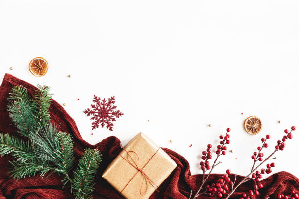 Christmas composition. Gift box, plaid, fir tree branch, red decorations on white background. Christmas, winter, new year concept. Flat lay, top view, copy space