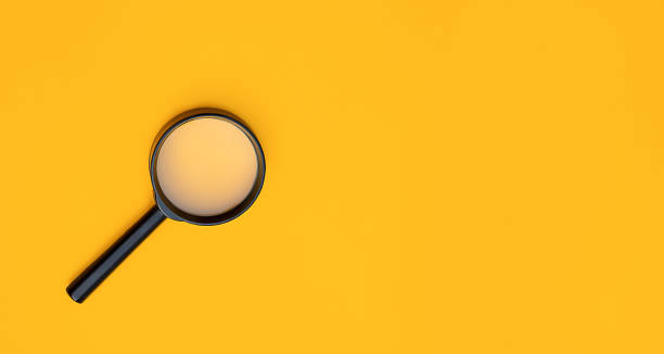 istock Magnifying glass on yellow background 1287389543