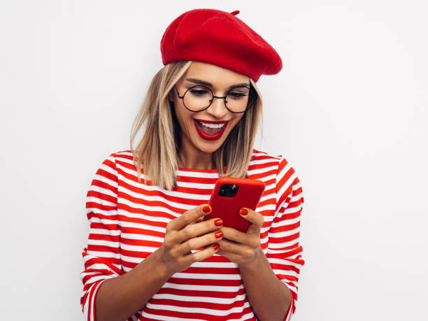 istock Beautiful smiling woman using smart phone 1287390909