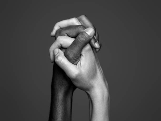 istock Interracial friendship. Human hands 1287391711
