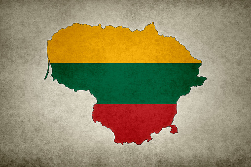 Grunge map of Lithuania with its flag printed within its border on an old paper.