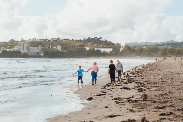 istock Family Stroll Along the Beach 1287391927