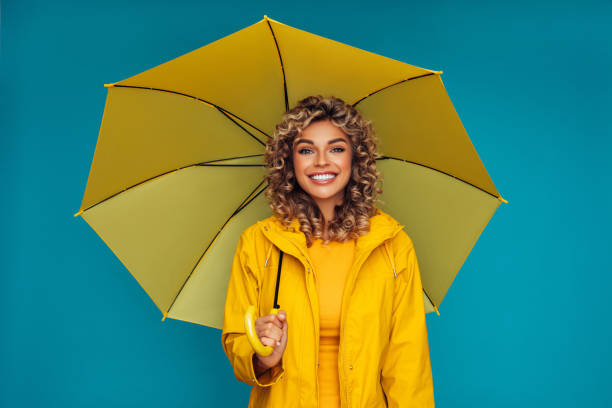 istock Girl with yellow umbrella 1287392033