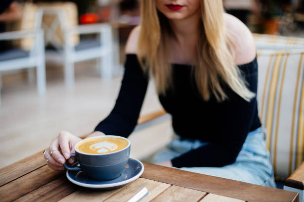 istock Lady's hands holding cup with coffee 1287392375