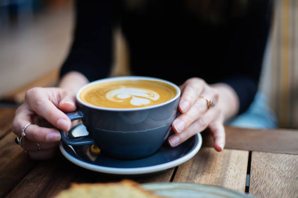 istock Lady's hands holding cup with coffee 1287392482