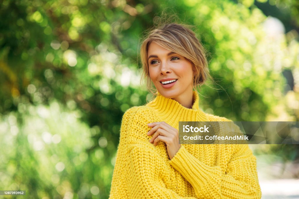 Smiling young woman outdoors Springtime Stock Photo
