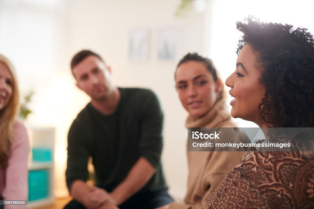 Woman Speaking At Support Group Meeting For Mental Health Or Dependency Issues In Community Space Discussion Stock Photo