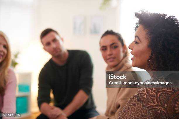 Woman Speaking At Support Group Meeting For Mental Health Or Dependency Issues In Community Space Stock Photo - Download Image Now