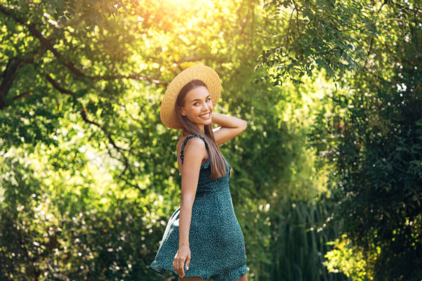 Smiling young woman walking in the park