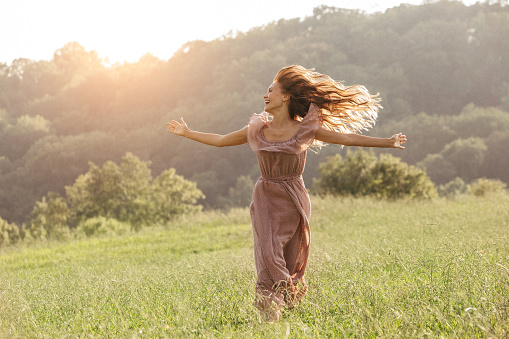 Beautiful woman running on the field