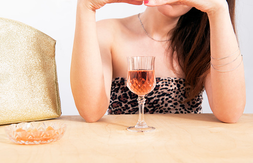 Relaxed woman drinking her cocktail champagne in dining table