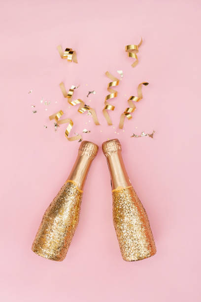 istock Sparkling wine, gold champagne bottle with glitter. 1287398707