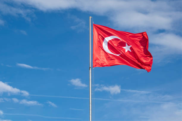 istock Turkish flag on a cloudy blue sky background. 1287399279