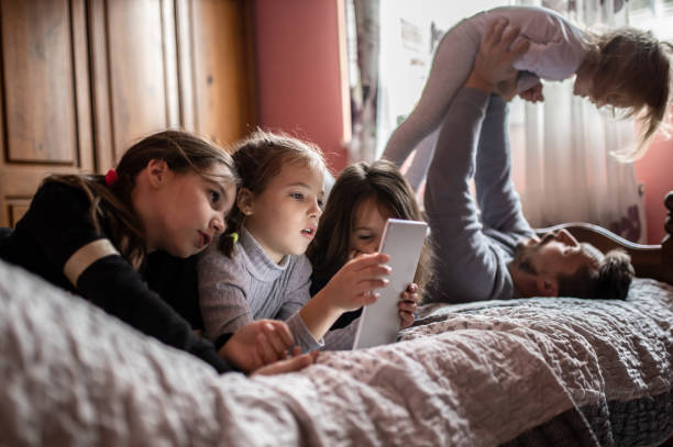 istock Single young father with his daughters at home 1287399319