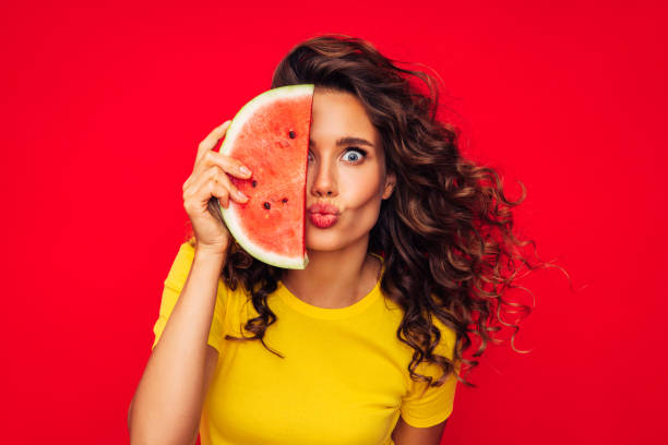 istock Smiling young woman holding watermelon 1287399321