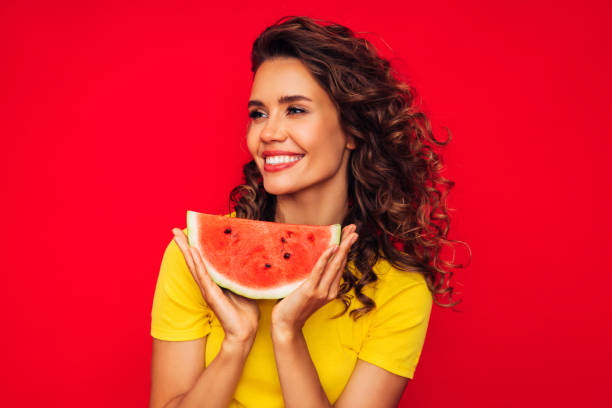 istock Smiling young woman holding watermelon 1287399393