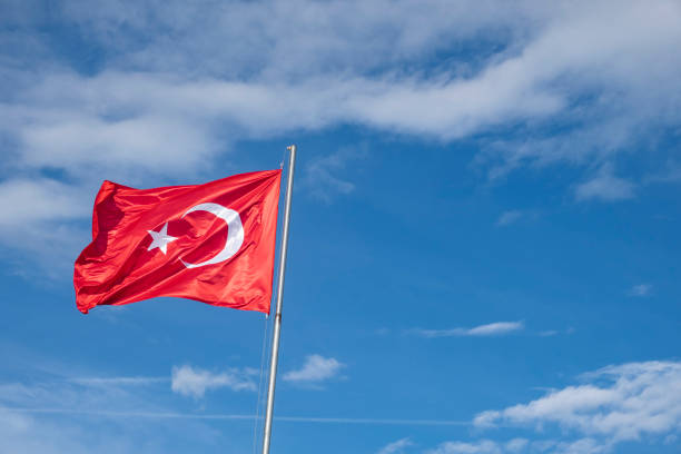 istock Turkish flag on a cloudy blue sky background. 1287399419