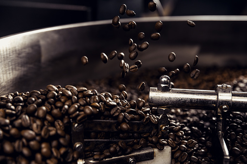 Fresh brown coffee beans in coffee roaster