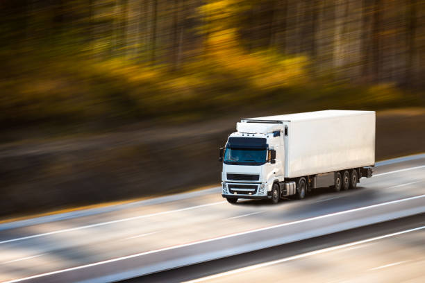 White truck with white semi-trailer on the road in autumn White truck with white trailer on the road in autumn russian highways stock pictures, royalty-free photos & images