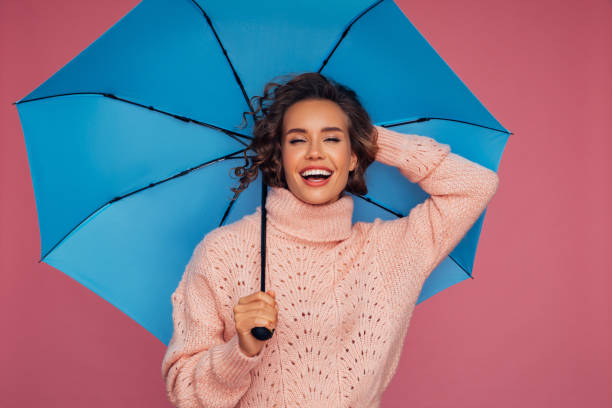 istock Girl with blue umbrella 1287400678