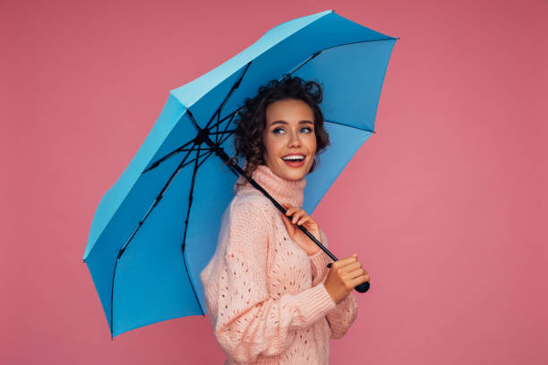 istock Girl with blue umbrella 1287400828