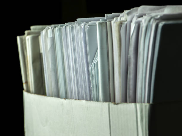 istock pile of paper documents in the office on black background 1287402571