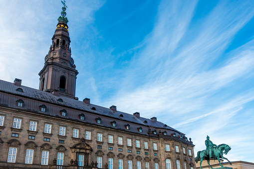Copenhagen, Denmark - Oct 19, 2018: Christiansborg Palace and the equestrian statue of Frederick VII by Herman Wilhelm Bissen at Slotsholmen.