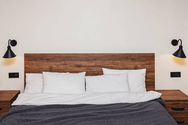 istock Modern bedroom interior. Bed with wooden headboard 1287404863