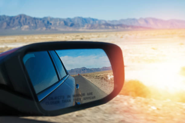 istock Car's side mirror close-up with blurred desert and mountains 1287406458