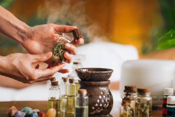 istock Ayurveda Aromatherapy Massage, Pouring Aromatic Oil in Essential Oil Diffuser 1287407100