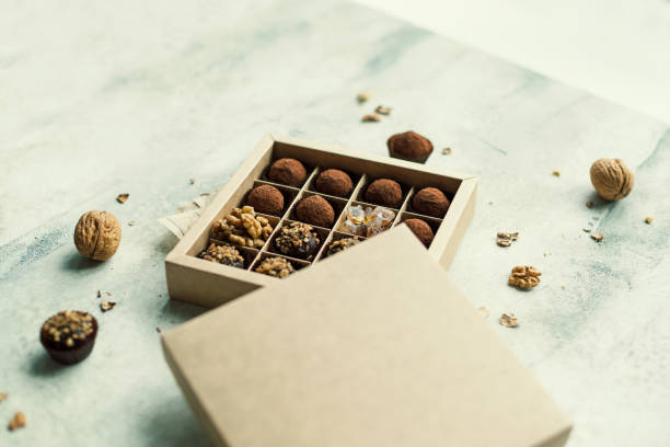 istock Chocolate truffle balls with cocoa powder in box 1287407138