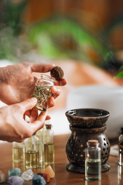 istock Ayurveda Aromatherapy Massage, Pouring Aromatic Oil in Essential Oil Diffuser 1287407153