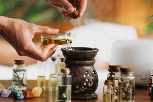 istock Ayurveda Aromatherapy Massage, Pouring Aromatic Oil in Essential Oil Diffuser 1287407645