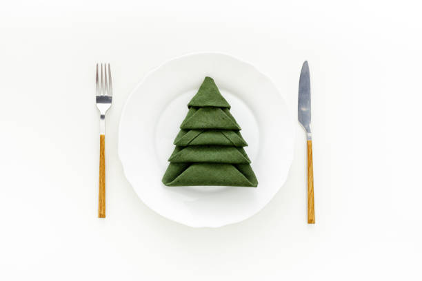 Christmas table setting with fir tree and gold toys on white background flat lay