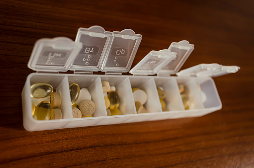 Plastic weekly pill or medicine box with litters, the Language of the russian on white background