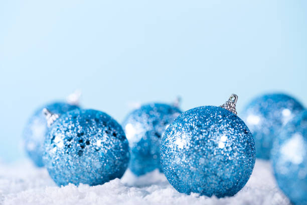 istock New Year Ball on snow closeup on blue background. Winter holidays 1287408708