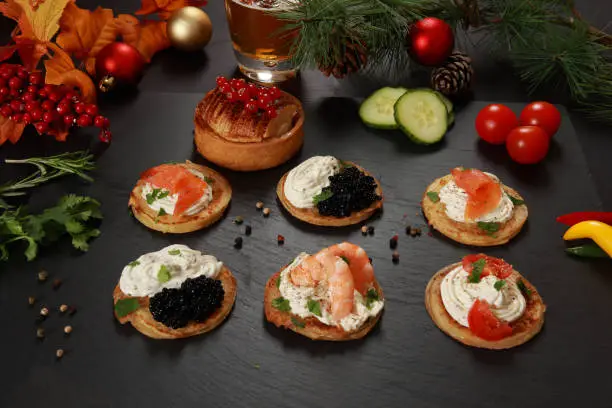 A selection of Savory Blini an Russian or Ukrainian cuisine with Blini Pancakes and cream cheese with festive decoration