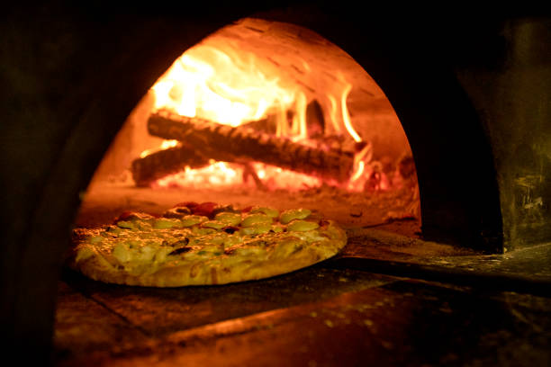 istock Italian pizza inside a wood oven 1287410320