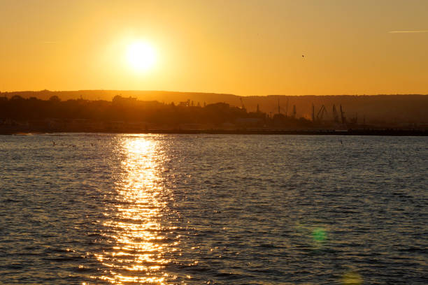 istock orange sunset on the sea, the setting sun is reflected in the water 1287410619