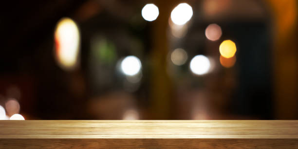 istock Empty wooden table top with blur coffee shop or restaurant interior background, Panoramic banner. 1287411395