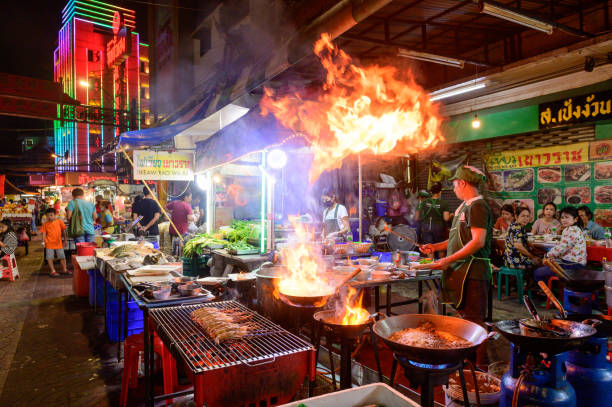 Chef cooking food at street side restaurant in Yaowarat road, Bangkok stock photo