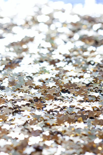 istock macro confetti golden stars, background 1287415259