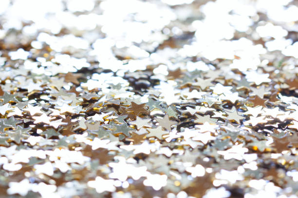 istock macro confetti golden stars, background 1287415324