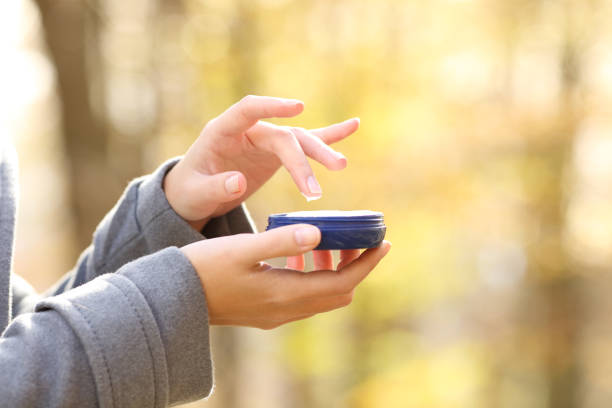 istock Woman hand holding moisturizer cream bottle in fall 1287419173