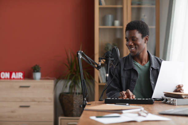 istock Smiling African-American Man Recording Song in Studio 1287419238