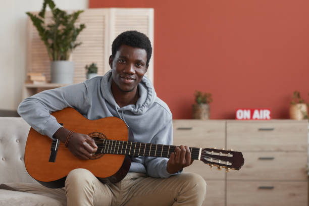 istock Smiling African-American Man Playing Guitar 1287419266