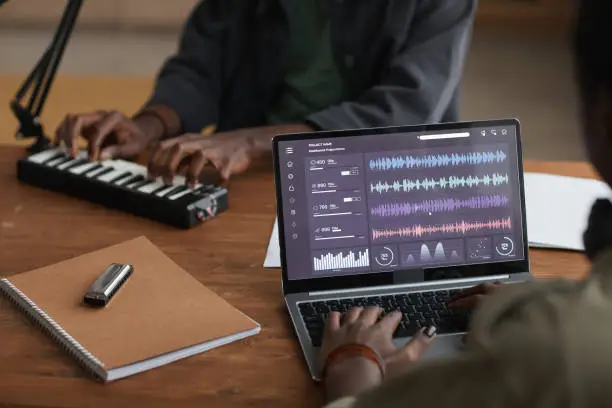 Photo of African-American Man Making Music via Laptop