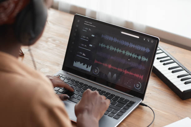 Female Musician Editing Music via Laptop